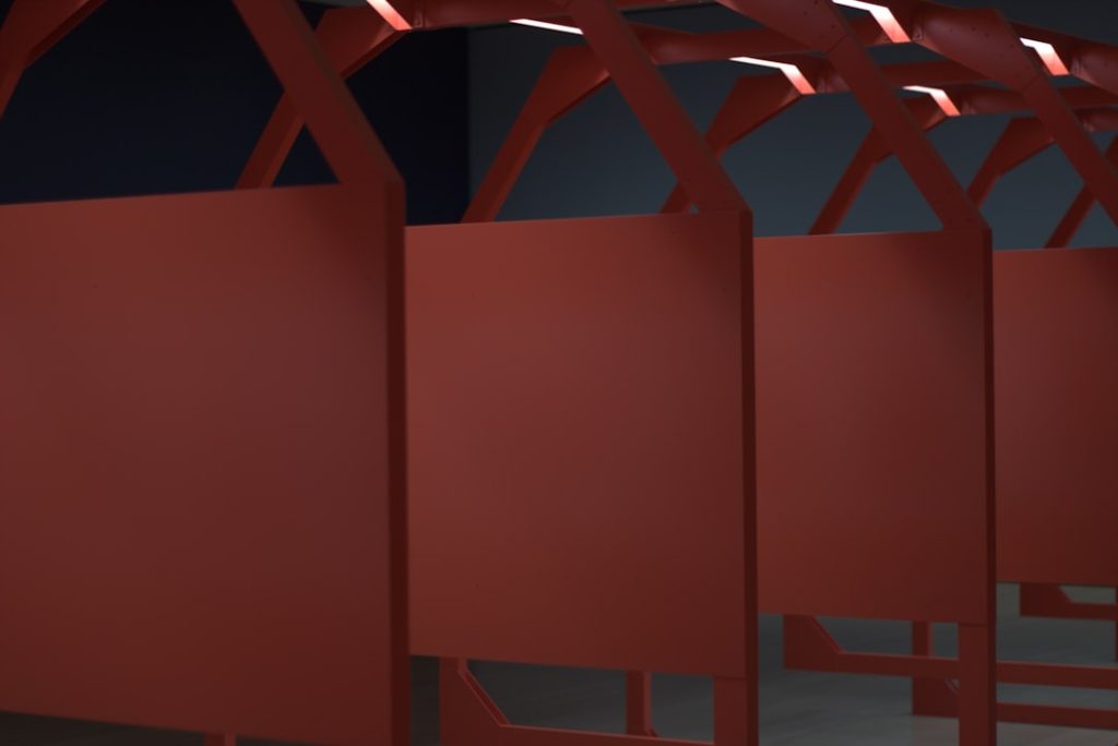 A row of red chairs sitting next to each other