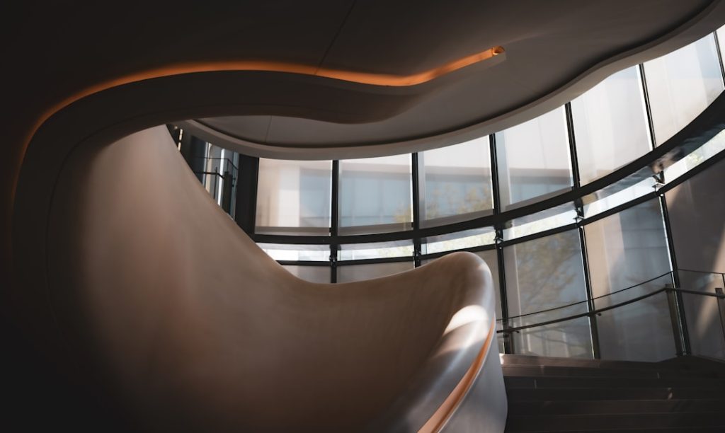 Modern curved staircase with ambient lighting