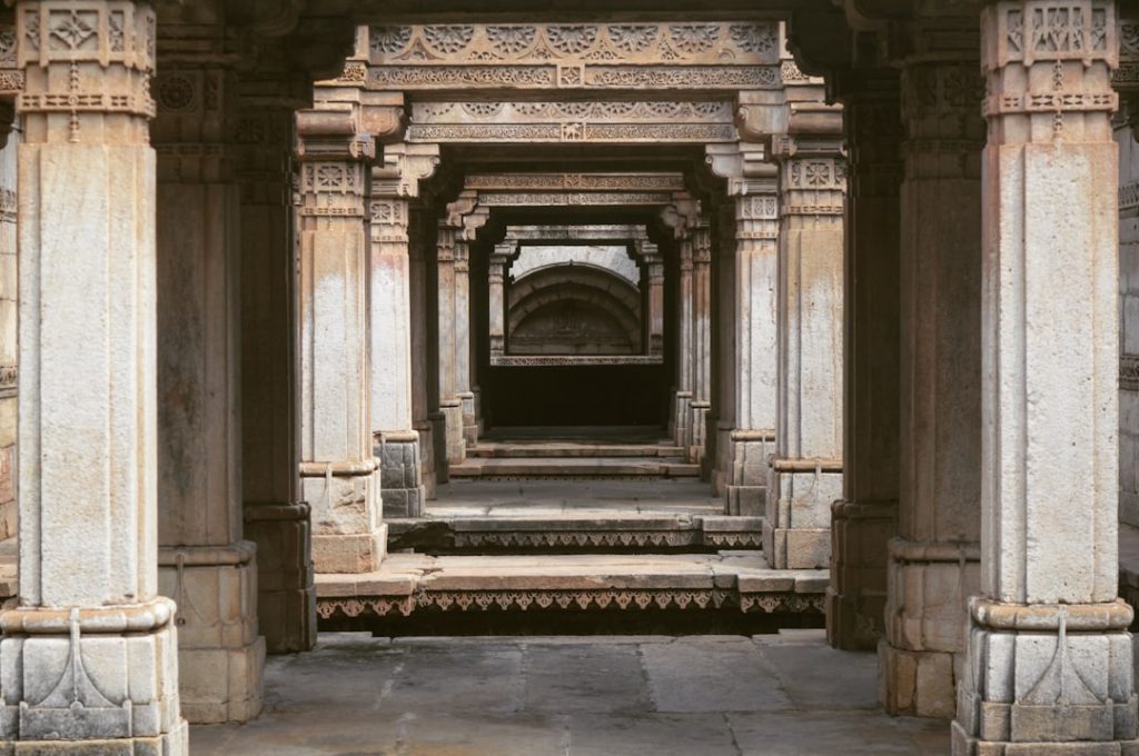 a stone structure with pillars and a doorway