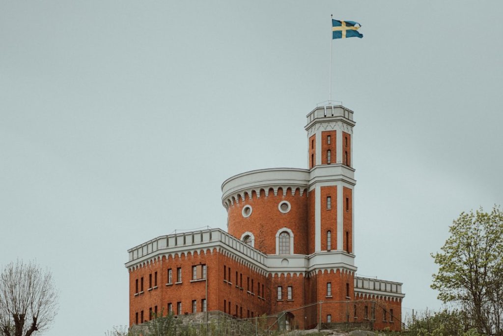 a large brick building with a flag on top of it
