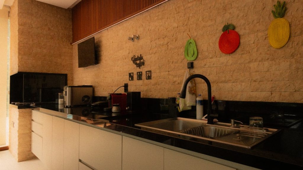 Modern kitchen counter with sink and appliances.