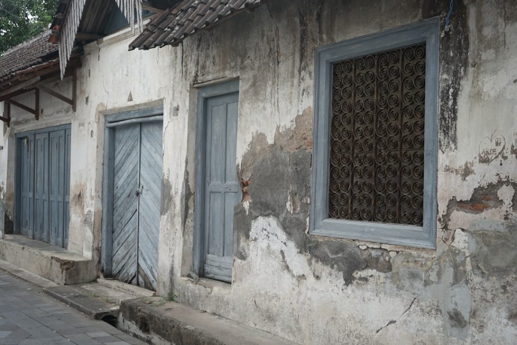 An old building with blue shutters on the windows